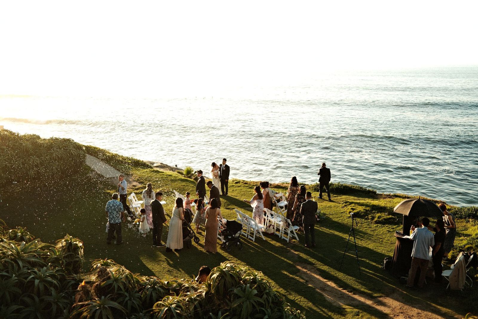 Cliffside wedding ceremony by the sea at sunset