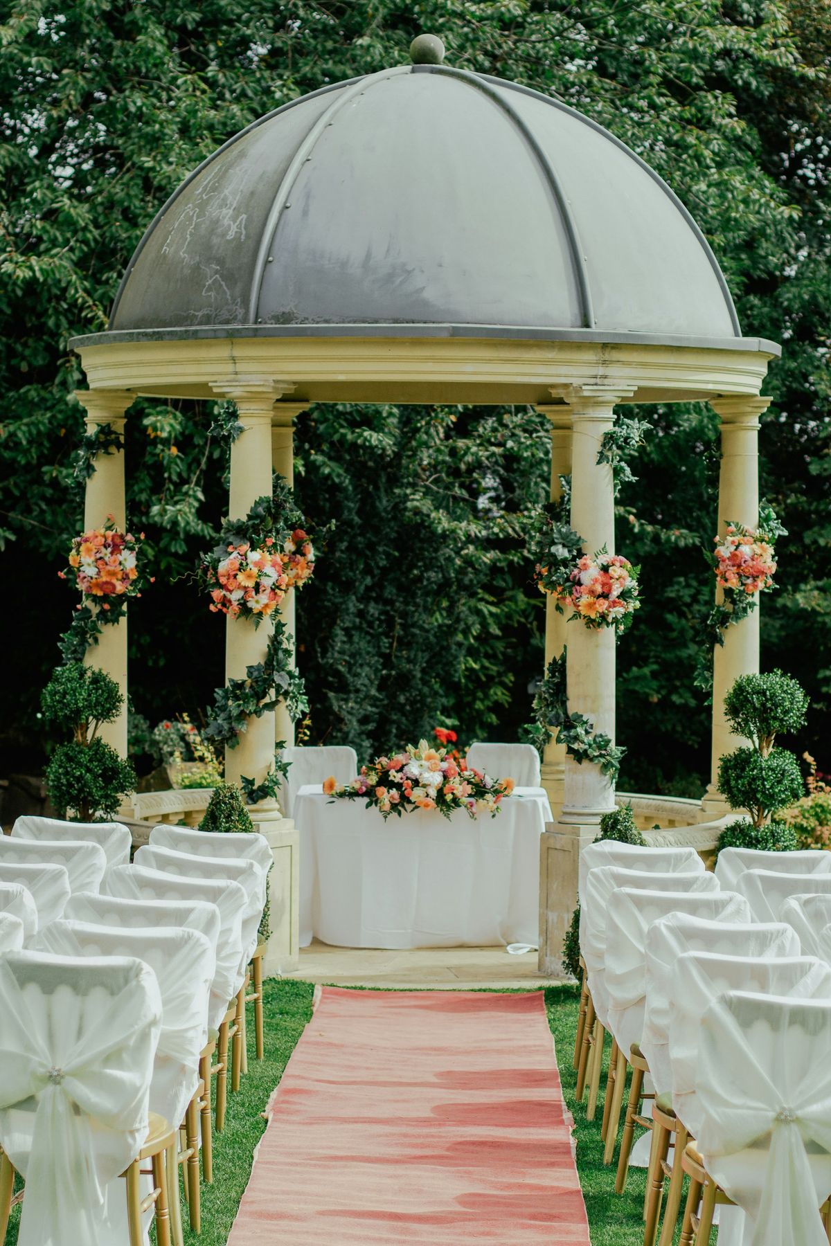 Garden wedding gazebo with white chairs