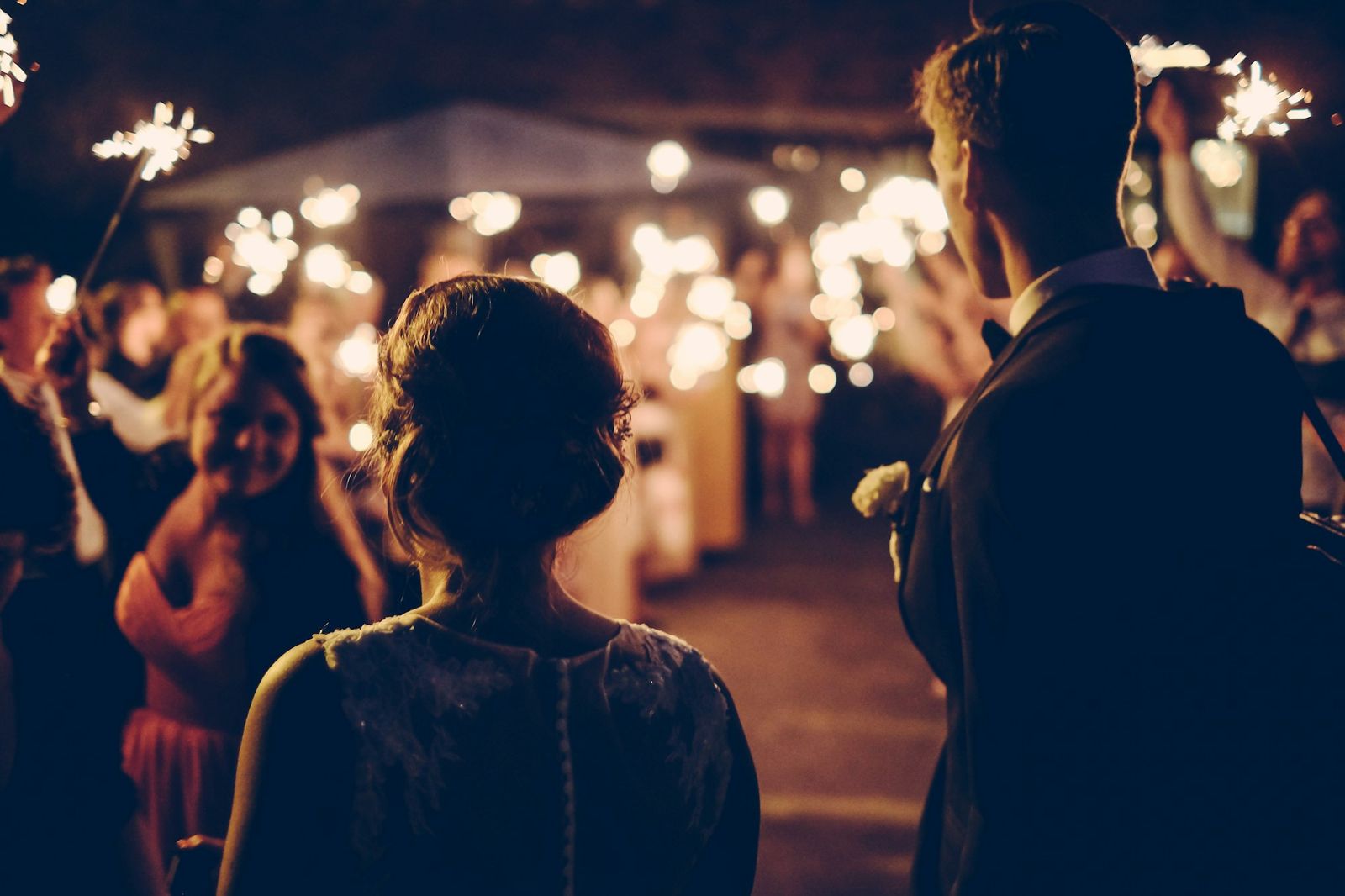 Guests with sparklers at an evening wedding