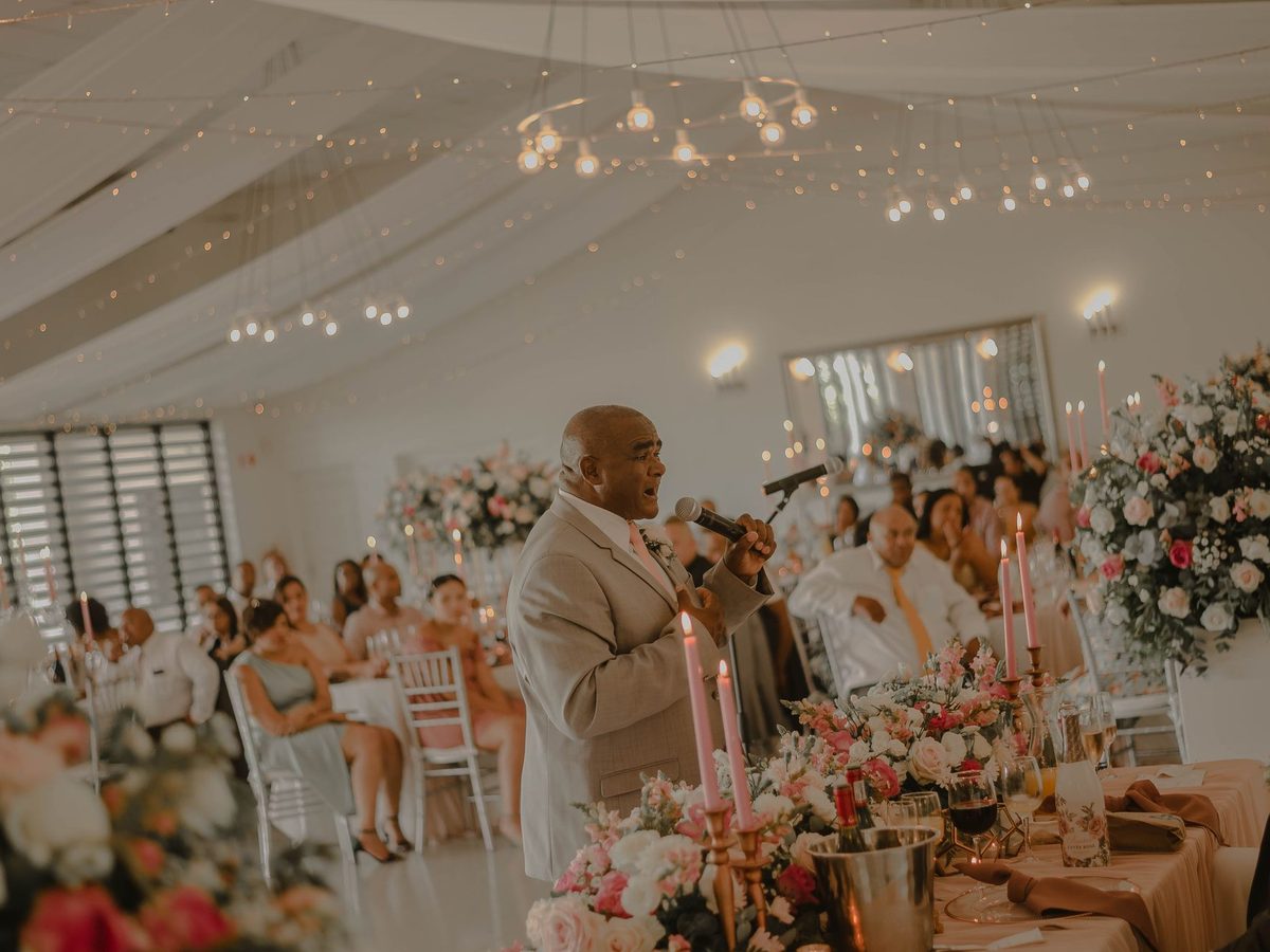 Guest giving a speech with a microphone at a wedding reception
